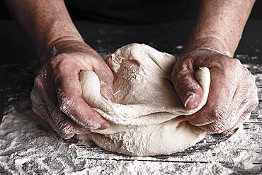 Cooking dough by elderly woman cook hands for homemade pastry bread, pizza, pasta recipe preparation on table background