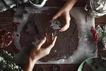 Preparing Christmas cookies. Dough on the table with baking dishes