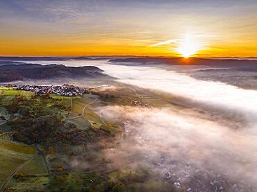 Drone view of fog, sunrise over valley Remstal, region Swabian Forest, Baden-Wuerttemberg, Germany, Europe