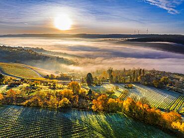 Drone view of sunrise with fog over valley Remstal, region Swabian Forest, Baden-Wuerttemberg, Germany, Europe