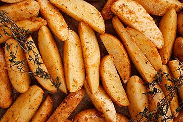 Roasted potatoes in the oven with spices and herbs