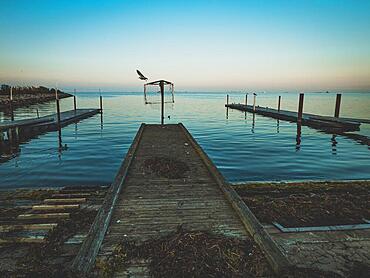 Wooden pier by the sea, sunset at water