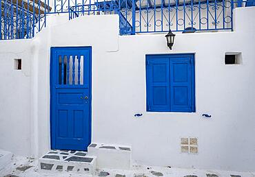 House facade with blue entrance door and shutters, Cycladic white houses, alleys of the old town Chora, Mykonos Town, Mykonos, Cyclades, Greece, Europe