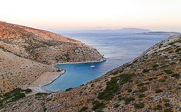 Evening atmosphere, sailing catamaran in a bay of Levitha Island, Greek island, South Aegean Sea, Greece, Europe