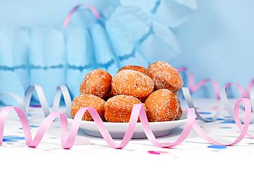 Small German traditional Berliner Pfannkuchen, a donut without hole filled with jam. Traditional served during carnival