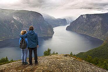 Father and daughter on Mount Prest looking over the Aurlandsfjord in Norway