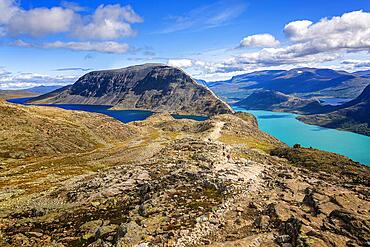 Hikers walking on the famous Besseggen ridge in the Jotunheimen mountains, Norway, Europe