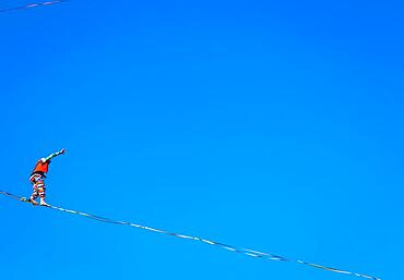 LANZO, ITALY - CIRCA OCTOBER 2020: Slackline athlete during his performance. Concentration, balance and adventure in this dynamic sport