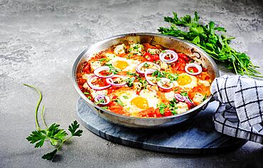 Shakshouka - poached eggs in sauce of tomatoes, peppers, onion and feta cheese. Keto meal and low carb