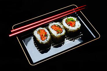 Vegetarian sushi, sushi filled with vegetables on tray with chopsticks