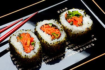 Vegetarian sushi, sushi filled with vegetables on tray with chopsticks