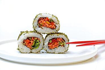 Vegetarian sushi on plates and chopsticks