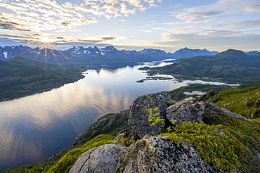 Sun star at sunset over the mountain peaks, view of fjord Raftsund and mountains, view from the top of Dronningsvarden or Stortinden, Vesteralen, Norway, Europe