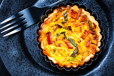 Quiche Lorraine - traditional French tart with pastry crust filled with bacon and leek