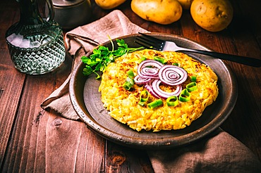 Tortilla - spanish omelette with potatoes and onions on wooden background