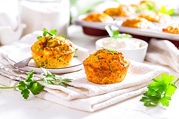 Delicious homemade zucchini muffins with feta cheese on white kitchen table