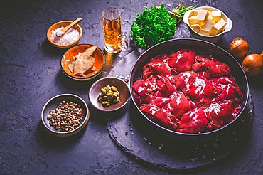 Raw chicken liver with cooking ingredients for liver pate, herbs and brandy