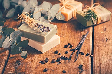 Natural organic soap bars with vanilla, coffee beans and eucalyptus on wooden background