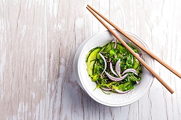 Traditional Japanese Sunomono salad with cucumber and wakame seaweed and sesame seeds