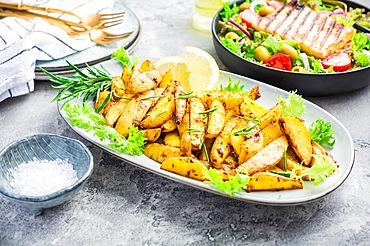 Potato wedges, oven roasted with freshly mixed salad and grilled cheese