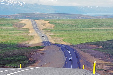 Very undulating road runs through barren landscapes, little traffic, endless expanses, yellow road markings, Myvatn, Iceland, Europe