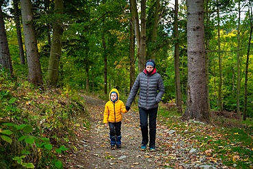 During the autumn, my mother and her little son go on a mountain trail. Polish mountains, Poland, Europe