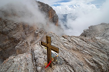 View obscured by clouds from the top of the Cima di Mezzo mountain (3154 m) with a beautiful cross on the top., Dolomites, Italy, Europe