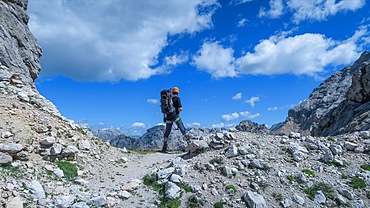 Tourist with equipment on a mountain trail in the Alps. Dolomites, Italy, Dolomites, Italy, Europe