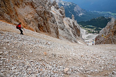 The descent of the tourist on the loose stones from the Forcella Staunies pass in the Dolomites. Dolomites, Italy, Dolomites, Italy, Europe