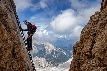 The tutor stands on a rake with a beautiful view in the background of the Alpine Dolomites. Dolomites, Italy, Dolomites, Italy, Europe