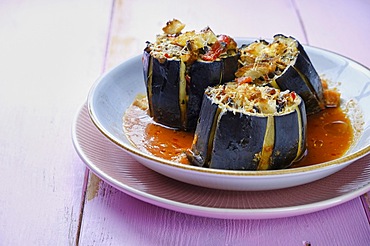 Stuffed aubergine, vegetarian, served on a plate