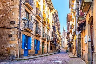 Fuenterrabia or Hondarribia municipality of Gipuzkoa. Basque Country. Main street of the old town and the church of Santa Maria in the background