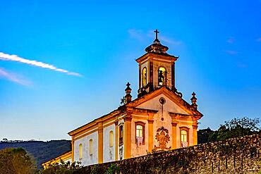 Old and historic 18th century church with its facade illuminated at dusk in the city of Ouro Preto, Minas Gerais, Brazil, Ouro Preto, Minas Gerais, Brasil, South America