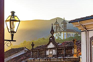 Facade of historic colonial style houses with their lanterns and church in the background in the city of Ouro Preto state of Minas Gerais, Brazil, Brasil, South America