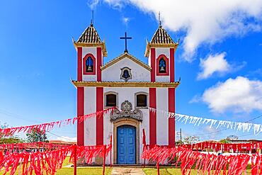 Small colonial-style chapel decorated with ribbons for a religious celebration in the small town of Lavras Novas, Ouro Preto district in Minas Gerais, Brasil