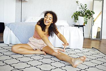 Cute african woman doing yoga at home in the morning. Healthy lifestyle and mindfulness concept