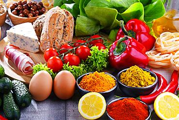 Composition with assorted organic food products on wooden kitchen table