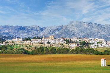 Panoramic view of the city of ronda, andalucia, spain with huge mountains in the background and farmland in the foreground