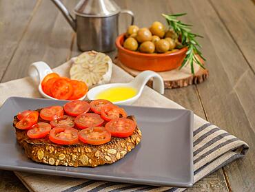 Toast bread with cherry tomato and olive oil with rosemary