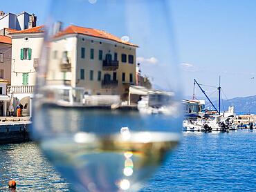 View through a wine glass, fishing village Valun, island Cres, Croatia, Europe