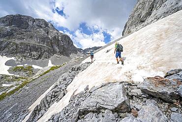 Mountaineers climbing the Hochkoenig, Rocky mountain landscape with remnants of snow, Berchtesgaden Alps, Salzburger Land, Austria, Europe