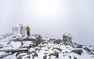 Climbers at the top of Snohetta Mountain, with snow, Dovrefjell National Park, Oppdal, Norway, Europe