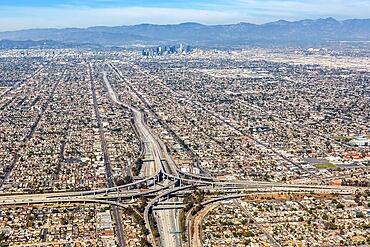 Aerial view of Harbor interchange and Century Freeway traffic with downtown Los Angeles, USA, North America