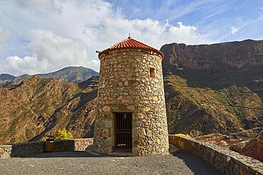 Old restored stone windmill, canyon walls, cloudy blue sky, Barranco de la Aldea, canyon, Gran Canaria, Canary Islands, Spain, Europe