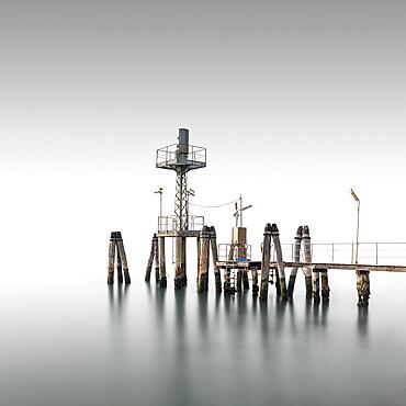 Minimalist wooden footbridge in fog in the Venice Lagoon, Italy, Europe