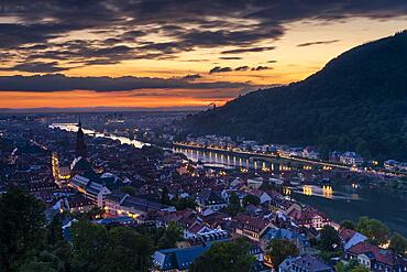 The city of Heidelberg after sunset, the old town, the river Neckar with the Old Bridge (Karl-Theodor-Bruecke), Heiligenberg on the right. Baden-Wuerttemberg, Germany, Europe