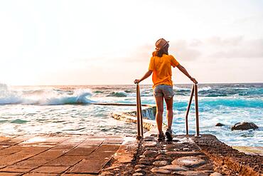 Tourist at sunset in the La Maceta rock pool on the island of El Hierro en la Frontera, Canary Islands