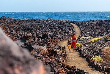 Walking along the beautiful volcanic path in the town of Tamaduste on the coast of the island of El Hierro, Canary Islands, Spain, Europe