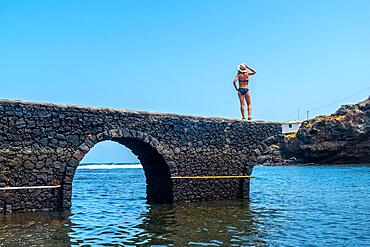 Portrait of a young woman on vacation in the seaside tourist village Tamaduste on the island of El Hierro, Canary Islands, Spain, Europe