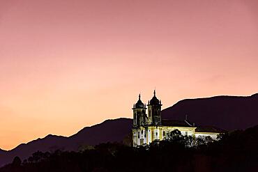 Historic baroque style church on top of the hill in Ouro Preto, Minas Gerais during sunset